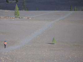 Joy crosses a cinder field, lassen national park