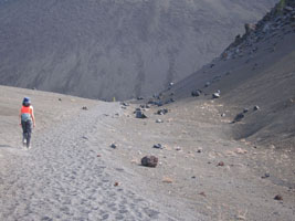 Joy crosses a cinder field, lassen national park