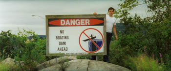 funny sign before a dam