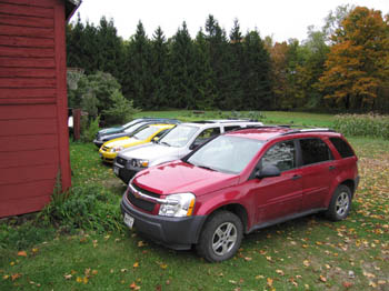 all the cars lined up by the barn