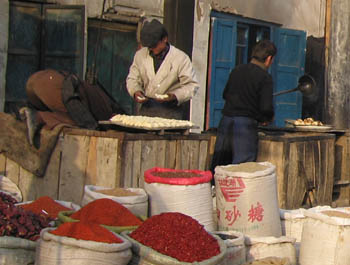 putting breads into the clay oven, kashgar market