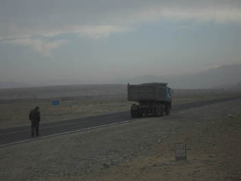 a truck stopped on a road towards Tibet
